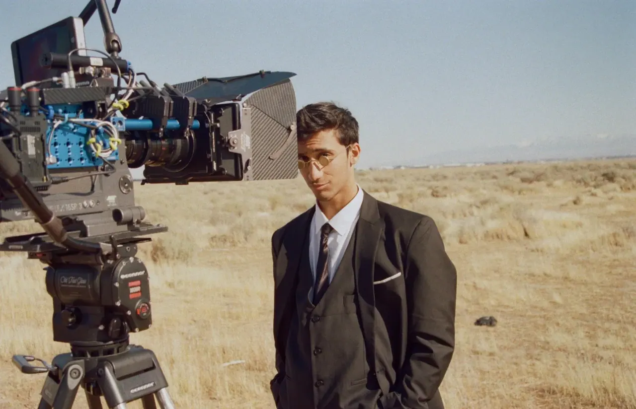 Avi Sahni on set beside a film camera